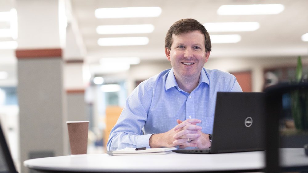 smiling male at desk