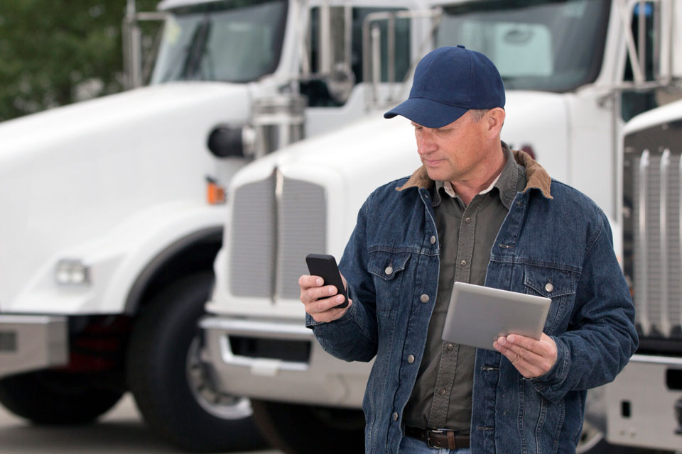 Truck driver looking at cellphone